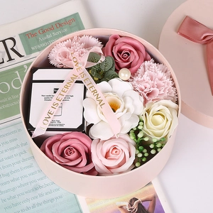 Romantic gift set with pink soap roses, carnations and a scented candle in a round box