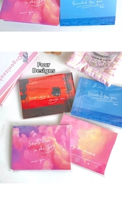 Set of four scenic art postcards featuring sunset ocean and starry sky with clear sleeves