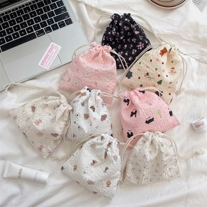 Detail of cute bear cartoon drawstring storage pouch made of bubble fabric material