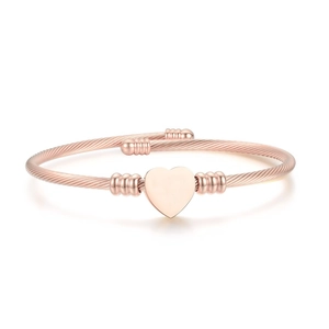Detailed view of rose gold cable wire bangle with a polished heart centerpiece