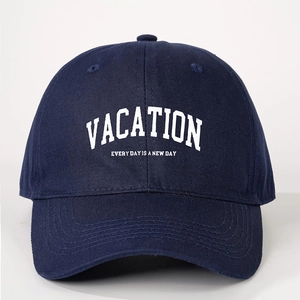 Navy blue cotton baseball cap featuring white Vacation embroidery with adjustable strap