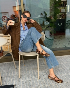 Detail of leopard print Mary Jane shoes paired with brown suede blazer and denim