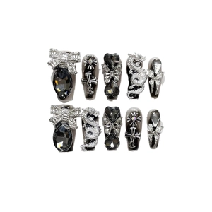Handmade black Y2K press-on nails with silver dragon and rhinestone bow charms