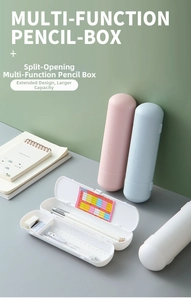 Macro view of multi-functional cylindrical pencil cases in pastel pink, blue, and white