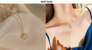 Detail of 18K gold heart necklace with pearl inlay and crystals on silk fabric