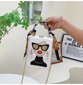 Detail of box bag featuring fashion female illustration and silk scarf handle detail