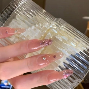 Pink gradient press-on nails with heart rhinestones and silver glitter details