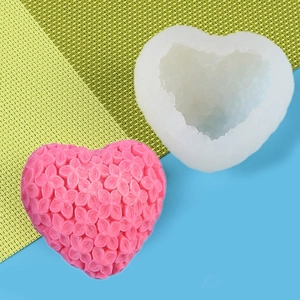 Detail view of 3D heart flower silicone mold and its pink textured craft candle output