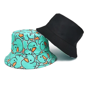 Reversible bucket hat with cute cartoon duck print in black and mint green fabric