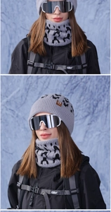 Detail of grey knitted winter hat and neck warmer set with black mottled patterns