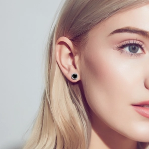 Elegant s925 silver stud earrings featuring a black moissanite stone on a female model