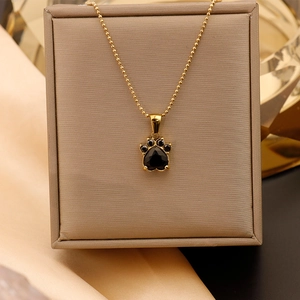 Détail du pendentif patte plaqué or 18K avec zircon noir en forme de cœur sur satin