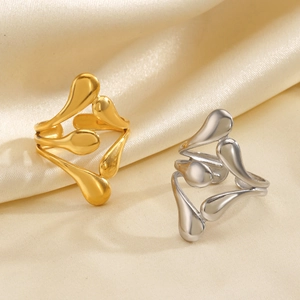 Minimalist adjustable open gold and silver teardrop rings on elegant satin fabric