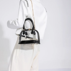 Chic shell-shaped transparent PVC crossbody bag with black trim and gold chain strap