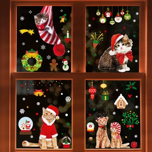 Christmas cat and gingerbread static window stickers on a wooden frame with holiday lights