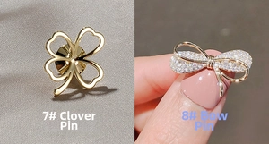 Détail de l'épingle trèfle poli et de la broche nœud sertie de strass brillants