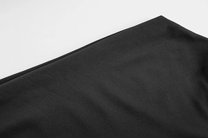 Detailed view of black knit fabric showing fine stitching and smooth texture on the dress