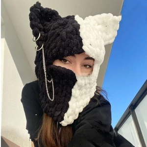 Detail of crochet cat ear balaclava with asymmetric color and silver chain accessories