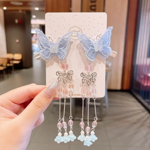 Detailed blue embroidered butterfly hair clips with elegant long beaded tassels and silver floral charm