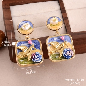 Macro view of Baroque pearl flower earrings with blue enamel bird and size dimensions