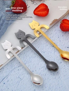 Detailed view of polished stainless steel cat-shaped coffee spoons in three colors