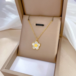 Minimalist gold titanium necklace with a white mother-of-pearl star pendant in a gift box