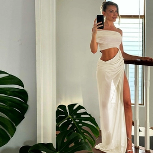 Detail of white two-piece set featuring mesh halter crop top and side hollow-out maxi skirt