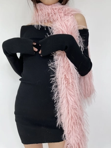 Detail shot of a soft pink faux fur scarf styled on a model wearing a black dress