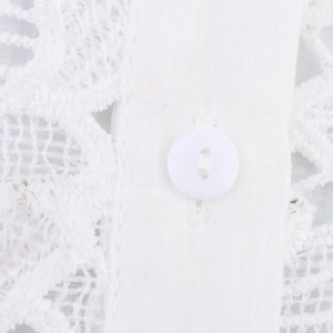 Close-up of white buttons and delicate lace texture on a sweet style flutter sleeve top