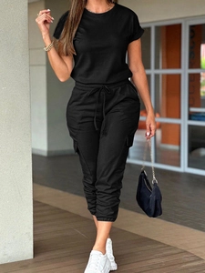 Detail of short-sleeved jumpsuit with cargo style pockets and drawstring waist in black