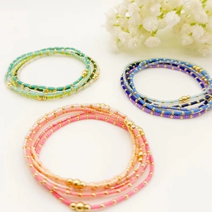 Handmade multilayer seed bead bracelets set with golden beads in various vibrant colors