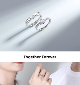 Macro detail of V-shaped couple rings with purple enamel and white crystal inlay