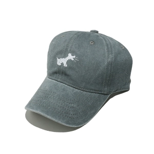 Macro detail of washed cotton fabric and small dog embroidery on grey-blue baseball cap