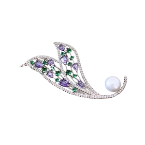 Elegant silver hollow leaf brooch with purple and green zircons and a white pearl