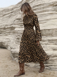 Detail of leopard print maxi dress with lantern sleeves and rustic western boots