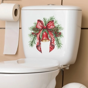 Adesivo WC natalizio con fiocco rosso, pigne e campane su serbatoio in ceramica bianca