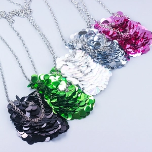 Detailed display of mini sequin crossbody bags in black, green, silver and pink with chains