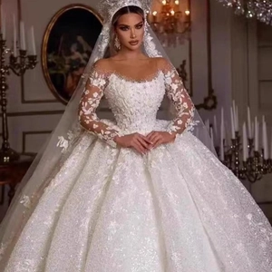 Luxury long sleeve lace wedding dress with large ball gown skirt and sparkling sequins