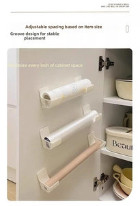 Adhesive cabinet storage brackets for kitchen rolls, foil, and cling film organization