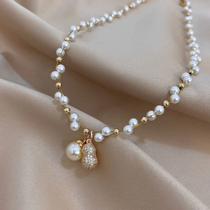 French retro pearl necklace with sparkling zircon peanut pendant on champagne satin