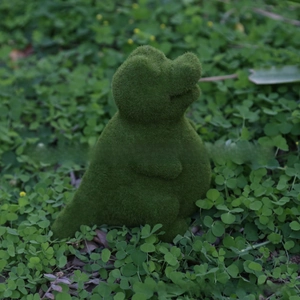 Detailed view of moss green dinosaur garden statue with realistic flocked texture