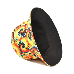 Detail of vibrant yellow, red and blue spiral tie-dye pattern on a foldable bucket hat