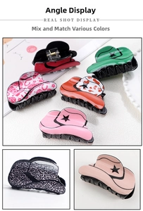 Detail view of western cowboy hat hair claws with leopard print and star patterns