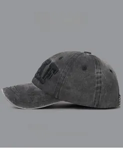 Detail of dark grey washed cotton baseball cap featuring 3D AF embroidery and worn texture