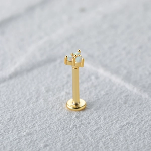 Macro shot of S925 sterling silver piercing stud with three white opal stones inlay