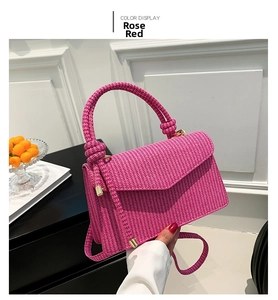 Close-up of fuchsia corduroy textured crossbody bag with decorative twisted knot handle