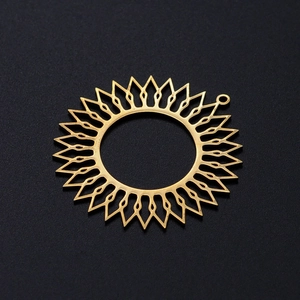 Polished gold sun pendant with radiant hollow design and top loop on black texture