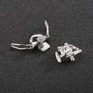 Detailed macro view of silver stainless steel clasp set on a textured black surface