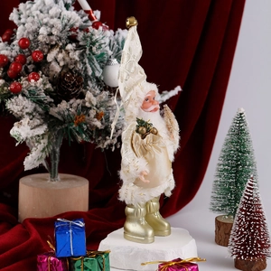 Detail of elegant white and gold standing Santa figurine on red velvet festive background