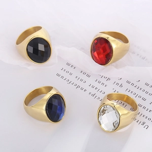 Macro shot of gold-plated stainless steel rings with colorful oval gemstone facets
